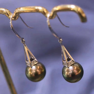 pearl earring with diamonds around it